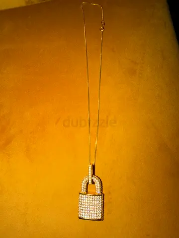 Gold-tone padlock pendant necklace with crystal pavé