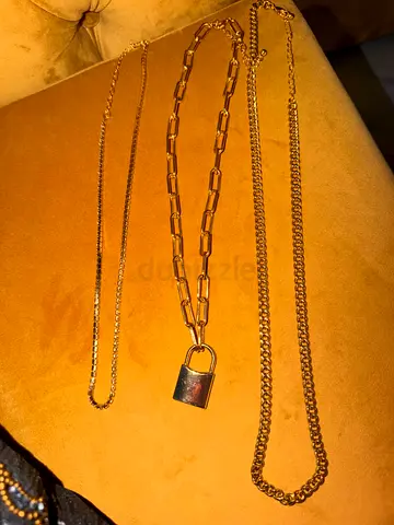 Set of three gold-tone chains with padlock pendant