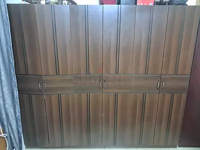 Large brown wooden wardrobe with 6 doors
