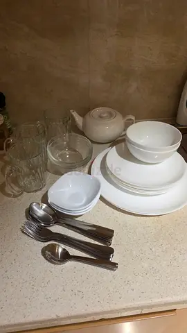 Used white dinnerware set with teapot, glasses and cutlery