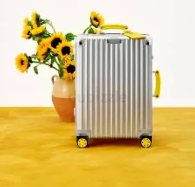 RimowaSilver hard-shell carry-on suitcase with yellow accents - good condition