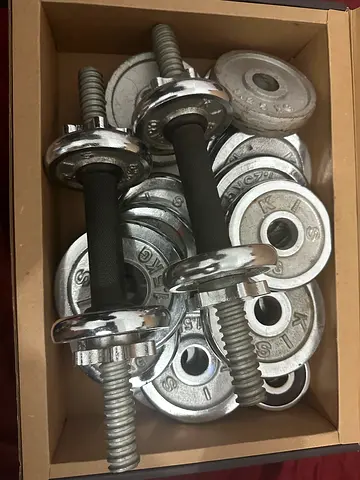 Adjustable Chrome Dumbbell Set with Weight Plates for gym. No proper casing. A laptop case used
