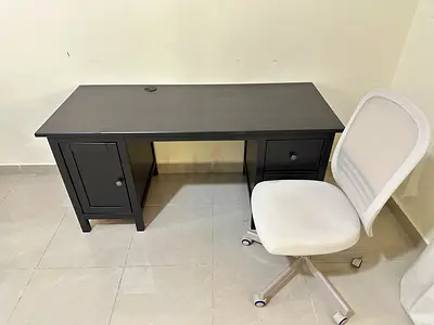 Black wooden office desk with storage cabinets and white swivel chair from ikea 150cm x 60cm
