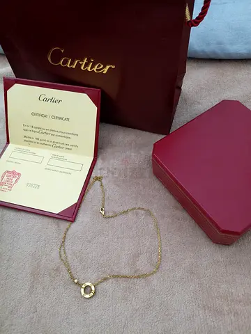 A gold necklace with a Cartier Love design, very similar to the original, suitable as a gift.