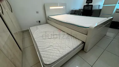 White gloss trundle bed frame with two mattresses - good condition