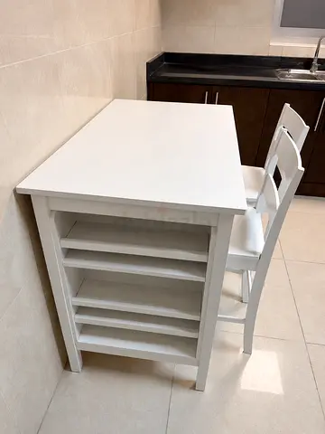 White kitchen island/cart with built-in shelves and 2 chairs