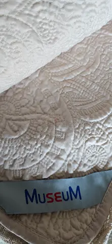 beige/cream quilted mattress topper/bedspread from MUSEUM shop hold expensive luxery fabric items