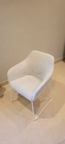 Light beige upholstered dining/armchair with metal legs