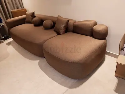 Modern brown curved 3-seater sofa with cushions - New