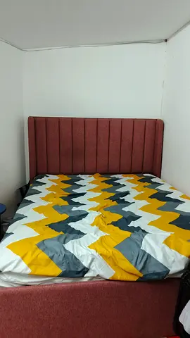 Queen upholstered bed frame with padded headboard — good condition
