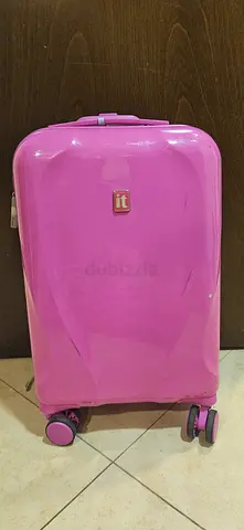 Pink hard-shell carry-on suitcase with wheels