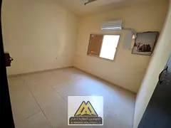 A spacious studio apartment with a separate kitchen.