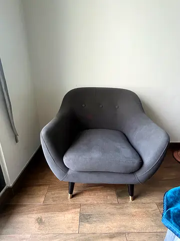 Grey upholstered accent armchair with wooden legs