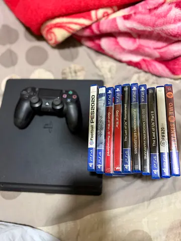 1TB PlayStation 4 Slim with 2x DualShock controller and 10 PS4 games - very Good condition
