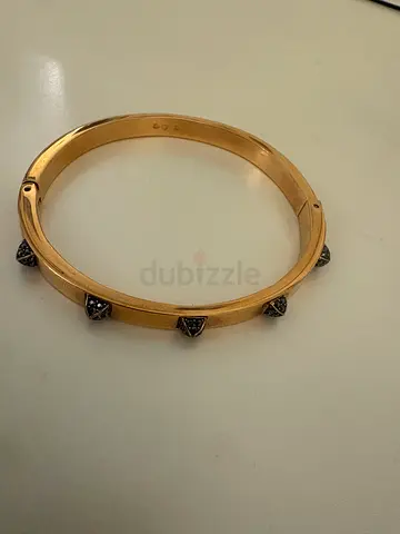 Swarovski Gold-tone bangle bracelet with decorative studs
