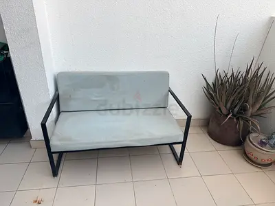 Compact 2-seater metal frame sofa with light grey cushions