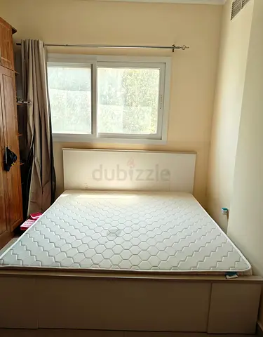 White double bed frame with mattress and storage