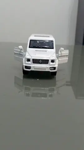 White die-cast toy SUV with opening doors