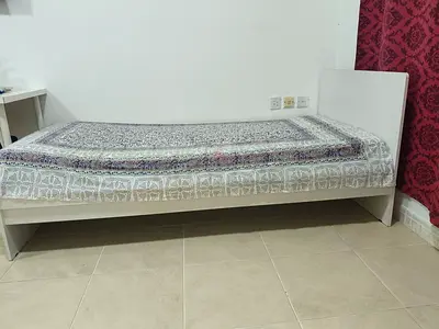 Simple single white bed frame with headboard and mattress