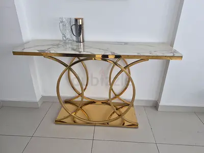 Marble-top gold console table with circular metal base