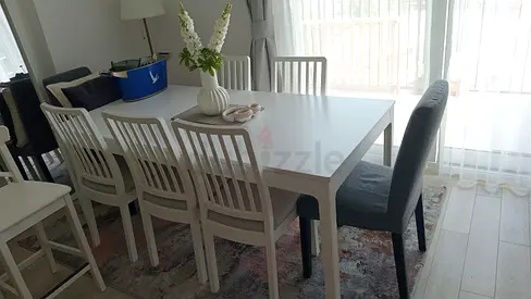 IKEA table and 6 white chairs
