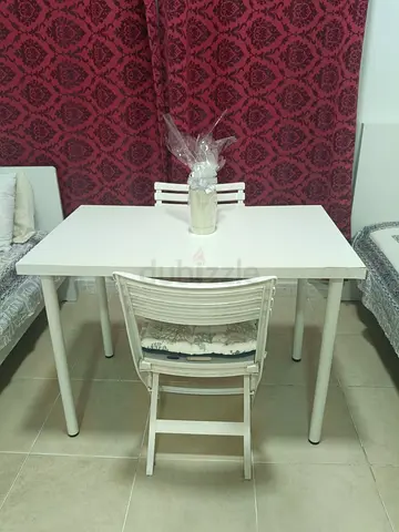 White Ikea dining table with matching Cosmopolitan chairs - compact set.