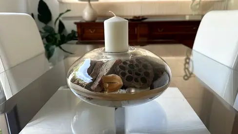 Glass decorative candle holder with dried potpourri