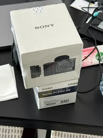 Sigma 30mm F1.4 DC DN Lens (open box) with camera (open box) brand new condition with 2 sd cards
