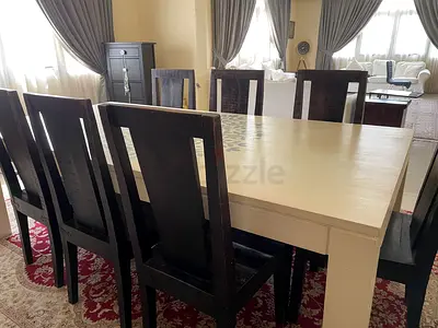 Solid wood 8 seater dining table with 7 dark chairs - used, good condition