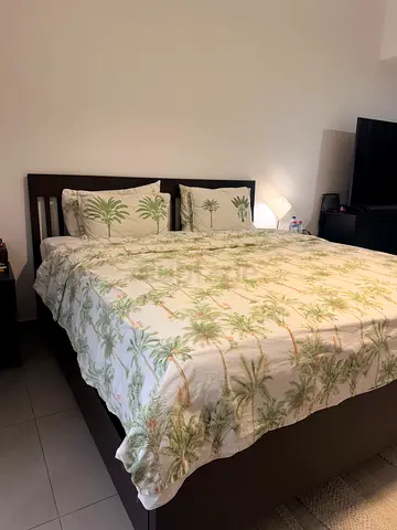 King size bed frame with mattress and bedding - dark wood