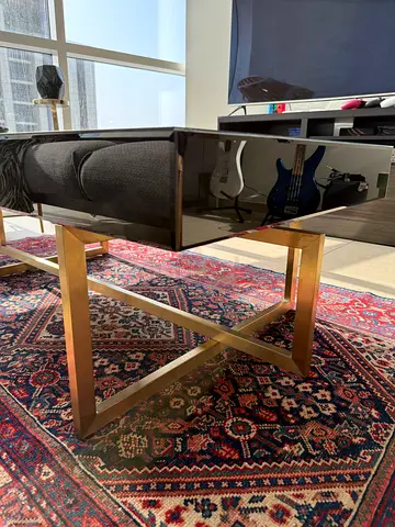 Modern glass top coffee table with gold X-frame