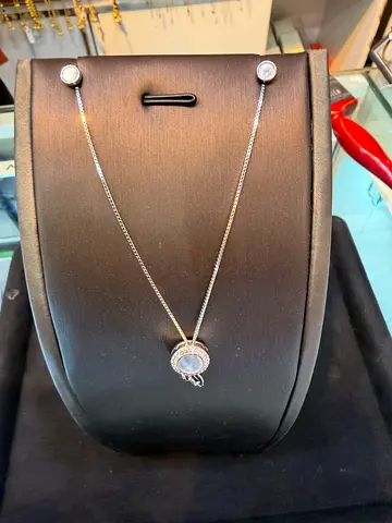 Silver necklace with round pendant and crystal accents