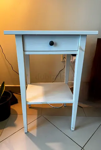 Simple white bedside table with drawer and shelf