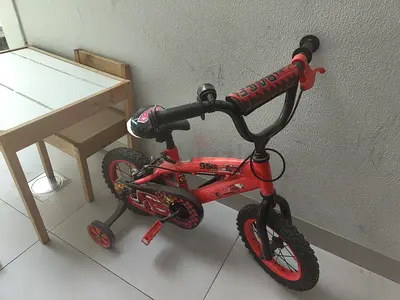 Kids red Cars-themed bicycle with training wheels, 12-inch