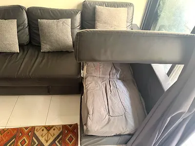 IKEA Black Leather L shape sofa with pull-out bed and storage - great condition