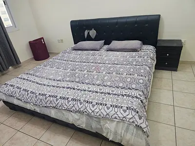 Queen cot and mattress with bit of tear in headboard