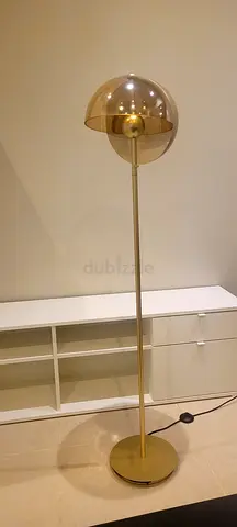 Gold floor lamp with smoked glass globe shade