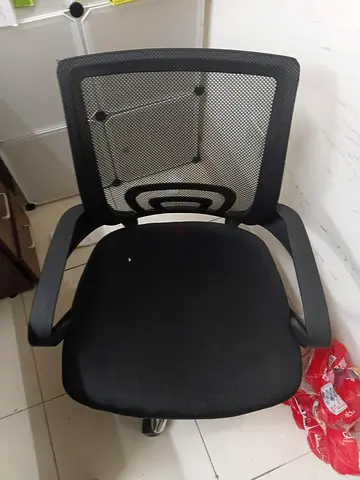Black mesh office chair with armrests — good used condition