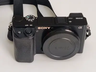 Sony Alpha a6100 mirrorless camera body (E-mount) with strap