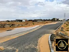 Townhouse plot in a prime location for sale in Ajman, Al Helio 1, including registration fees.