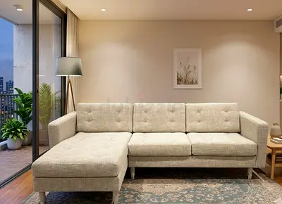 L-Shape Sofa in elegant beige fabric. Comfortable seating with a modern design, perfect for apartmen