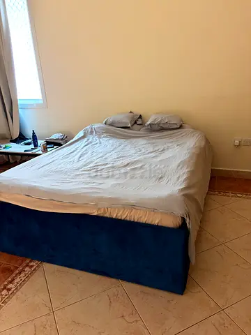 Blue upholstered bed base (queen size) in perfect condition