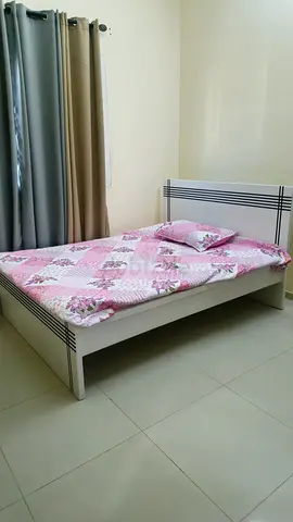 White wooden double bed frame with mattress