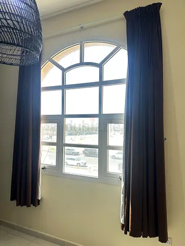 Pair of brown blackout curtains with curtain rod - used but still ok