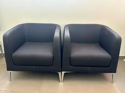 Pair of modern black armchairs with metal legs