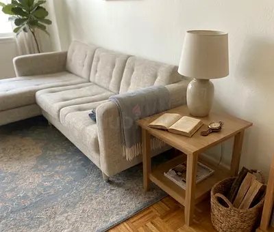 Modern sectional sofa with chaise lounge. Soft fabric upholstery, spacious seating, and a stylish ne
