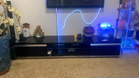 Low-profile black TV entertainment unit with storage - good condition