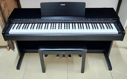 The Yamaha YDP-143B is an 88-key console digital piano (finished in Black Walnut) designed