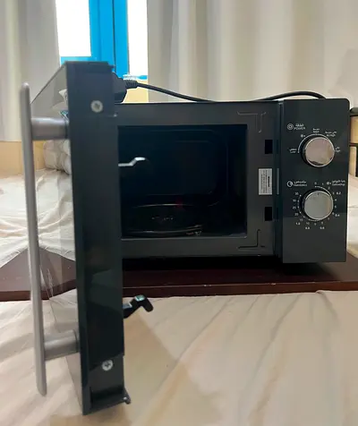 Compact countertop microwave oven in grey