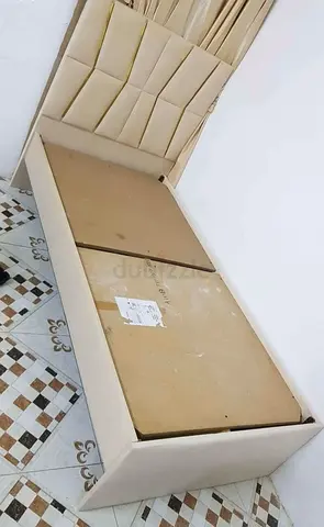 Single beige upholstered bed frame with headboard - good condition